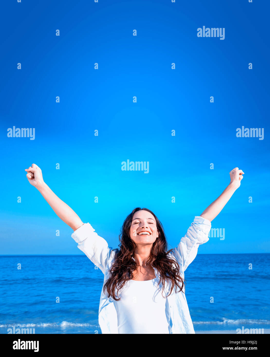 Happy woman smiling at the beach Stock Photo - Alamy