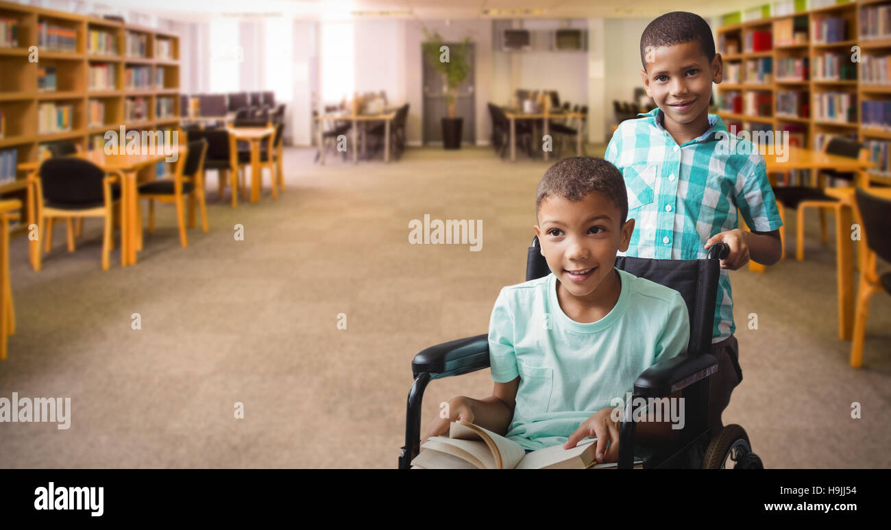 Composite image of boy pushing friend on wheelchair Stock Photo