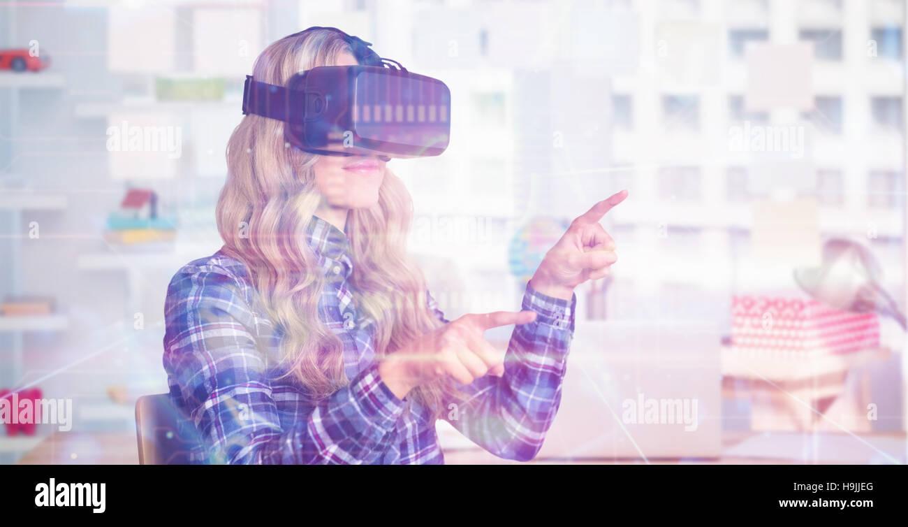 Composite image of pretty casual worker using oculus rift Stock Photo
