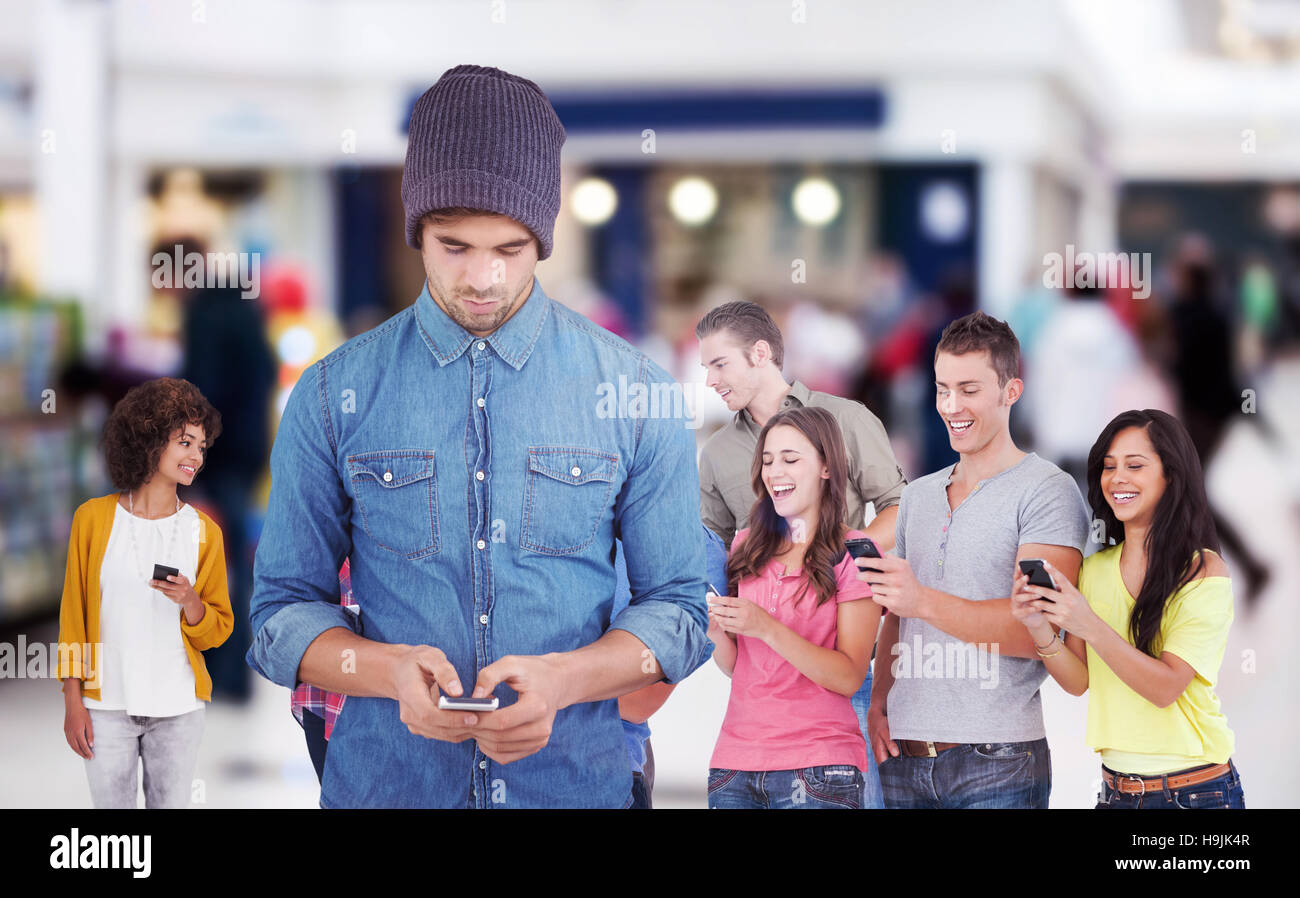 Composite image of hipster using mobile phone Stock Photo