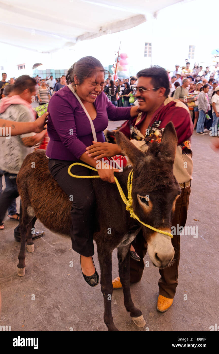 Woman riding a donkey Stock Photo