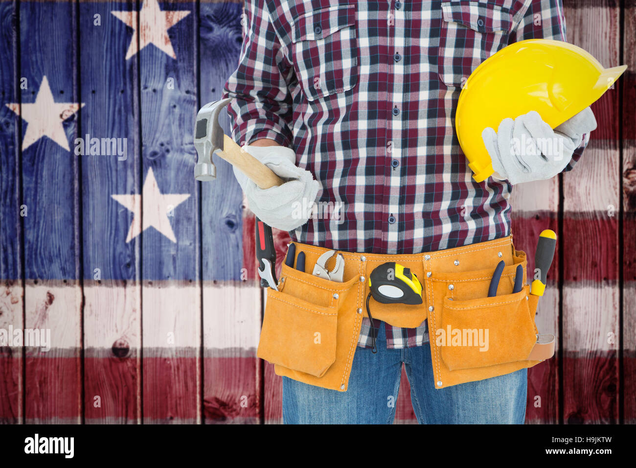 Composite image of handyman holding hard hat and hammer Stock Photo Alamy