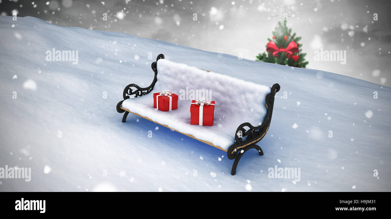 Composite image of snow covered bench with gift boxes Stock Photo