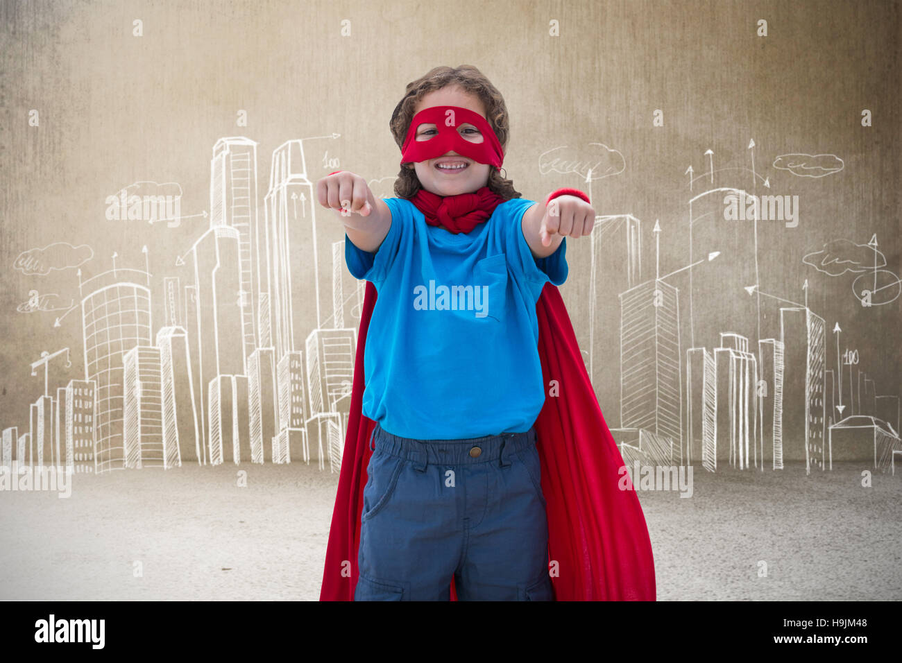 Composite image of boy in superhero costume Stock Photo