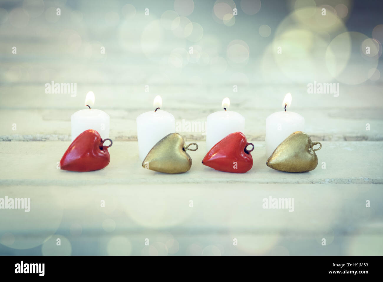 Candles burning on wooden plank Stock Photo