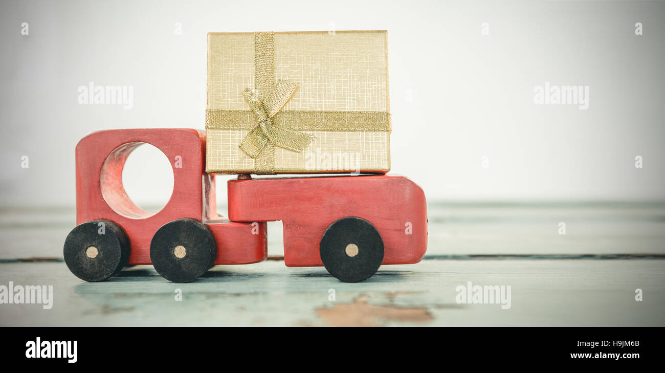 Toy tempo carrying christmas present against white background Stock Photo