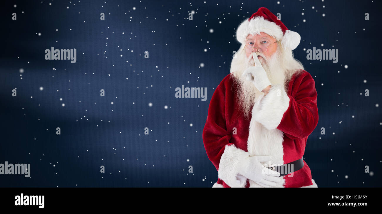 Composite image of santa asking for quiet to camera Stock Photo