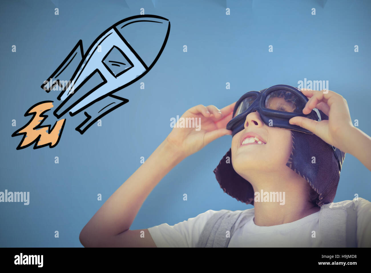 Composite image of cheerful boy with flying goggles Stock Photo