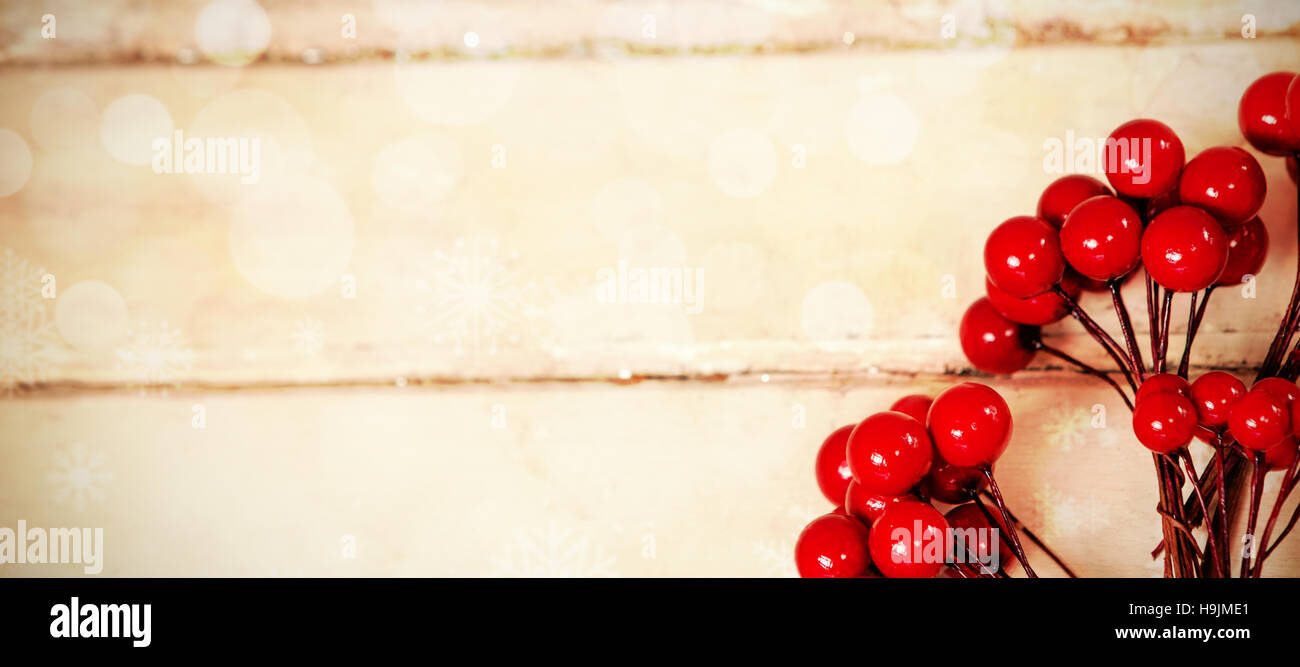 Fake red cherries on a plank Stock Photo
