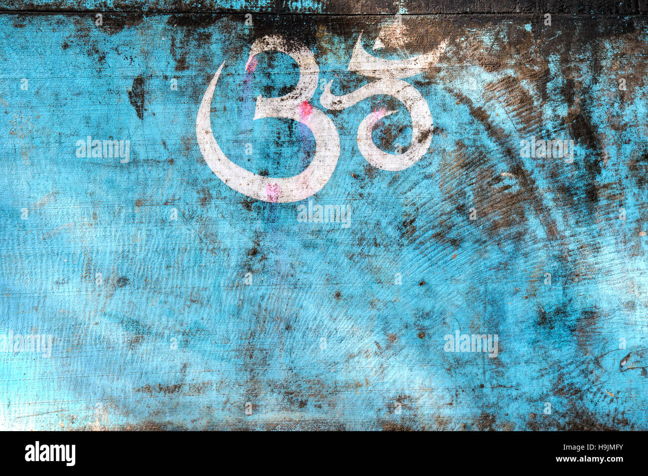 Painted Hindu OM / AUM symbol on an old blue indian cart. India Stock Photo