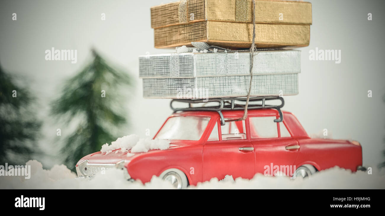 Toy car carrying christmas present on fake snow Stock Photo