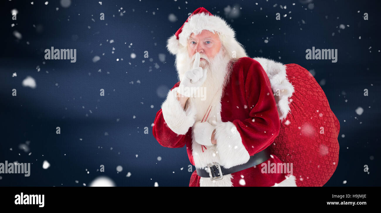 Composite image of santa asking for quiet with bag Stock Photo