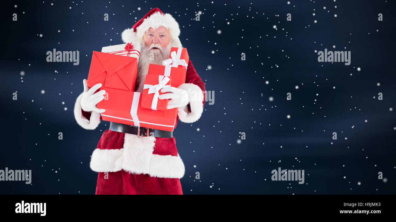 Composite image of santa carries a few presents Stock Photo