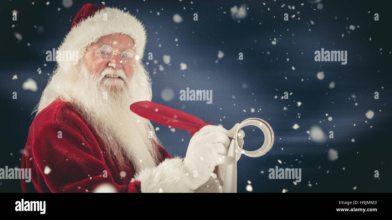 Composite image of father christmas writes a list Stock Photo