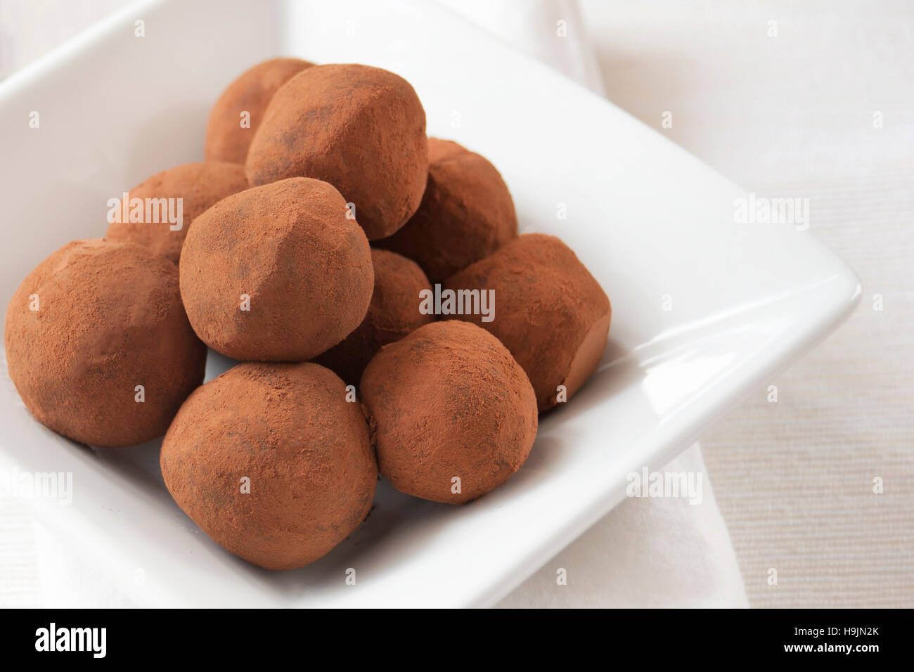 Hand Rolled Rich Chocolate Truffles dusted in Cocoa Powder, served in a