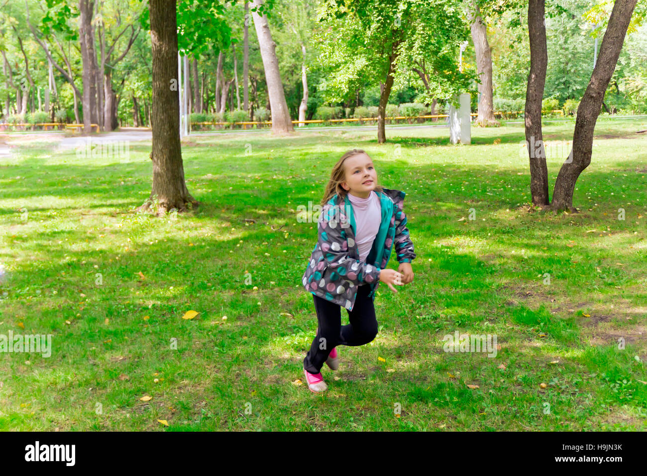 Photo of cute running girl in summer Stock Photo