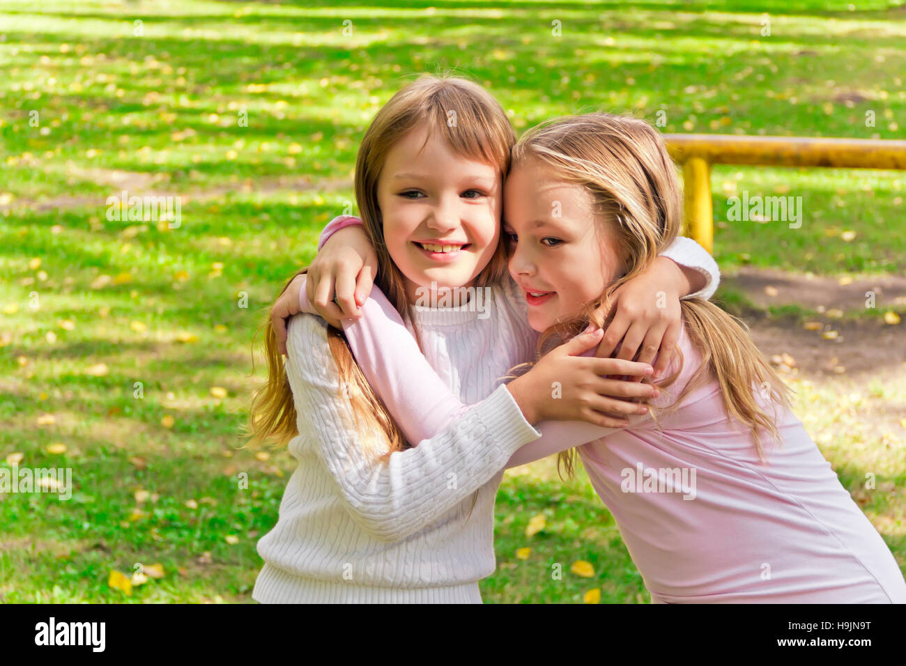 Photo of two embracing girls in summer Stock Photo - Alamy