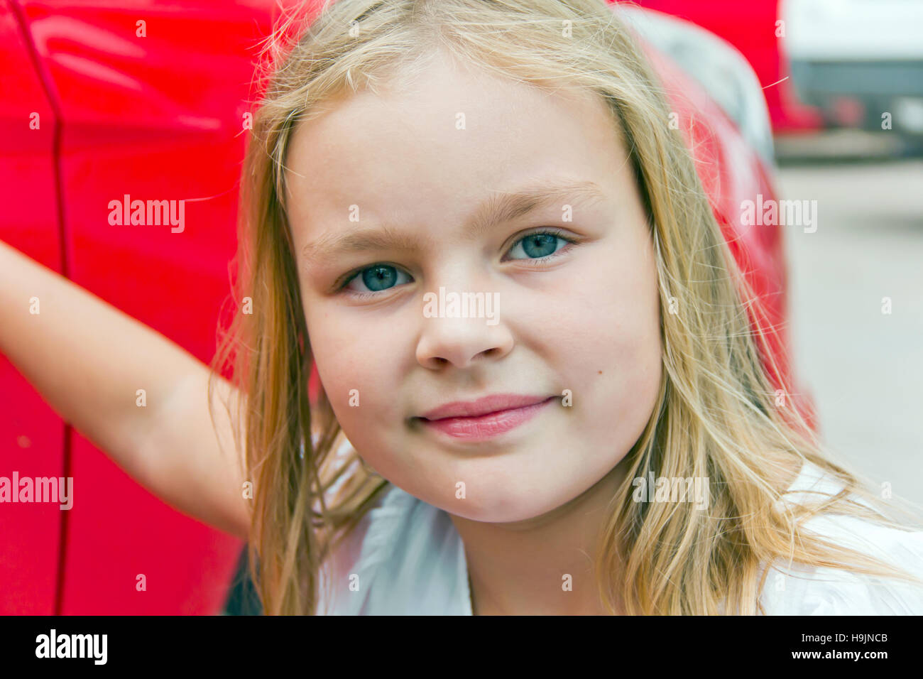 Cute girl with blond long hair and blue eyes Stock Photo - Alamy