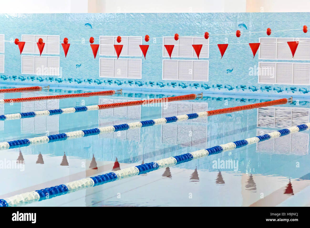 Photo of empty swimming pool with red flags Stock Photo