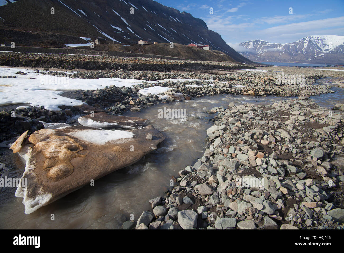 Melting snow and ice in river near Longyearbyen in spring, Svalbard / Spitsbergen, Norway Stock Photo