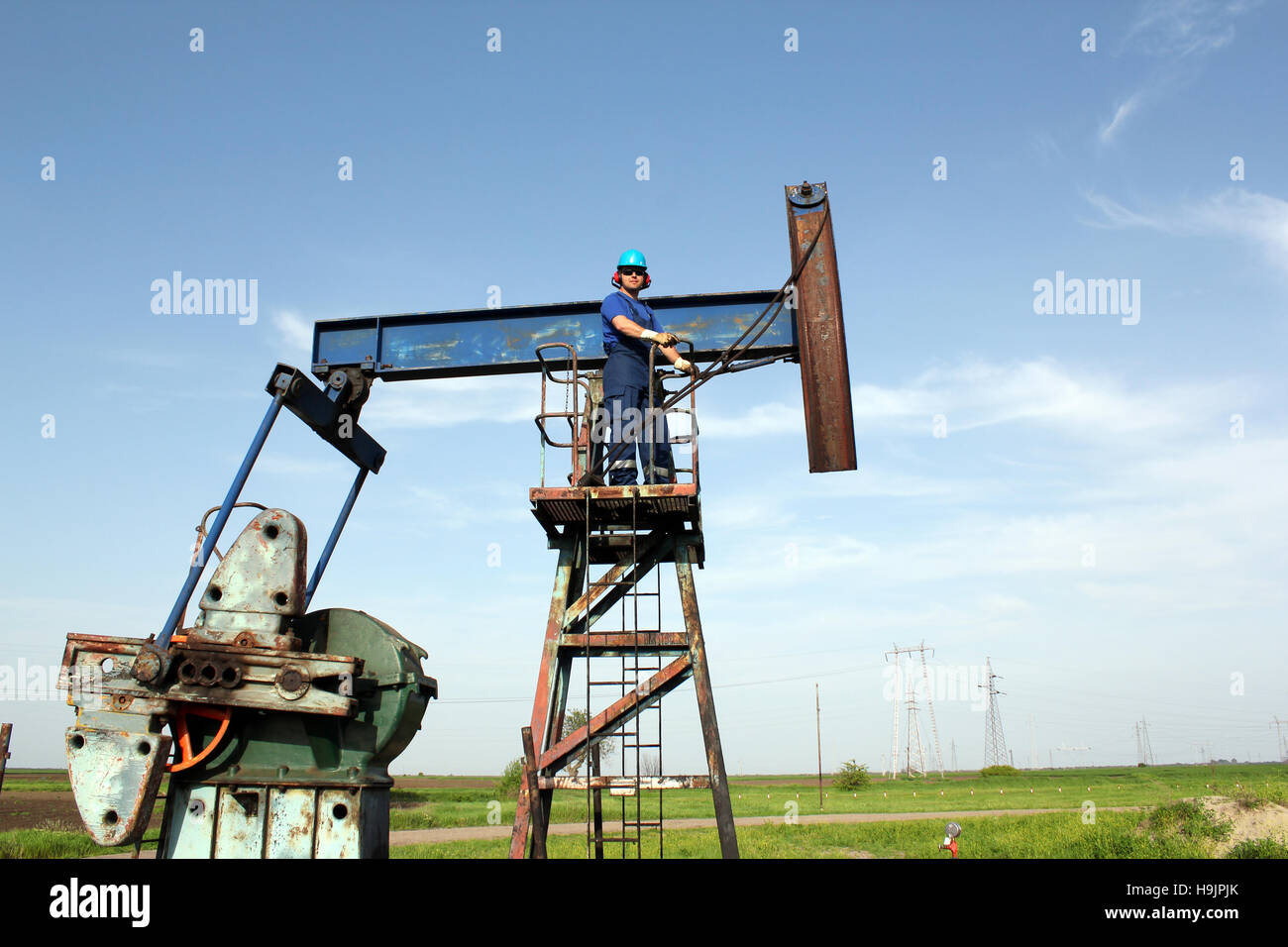 oil worker and pump jack industry scene Stock Photo