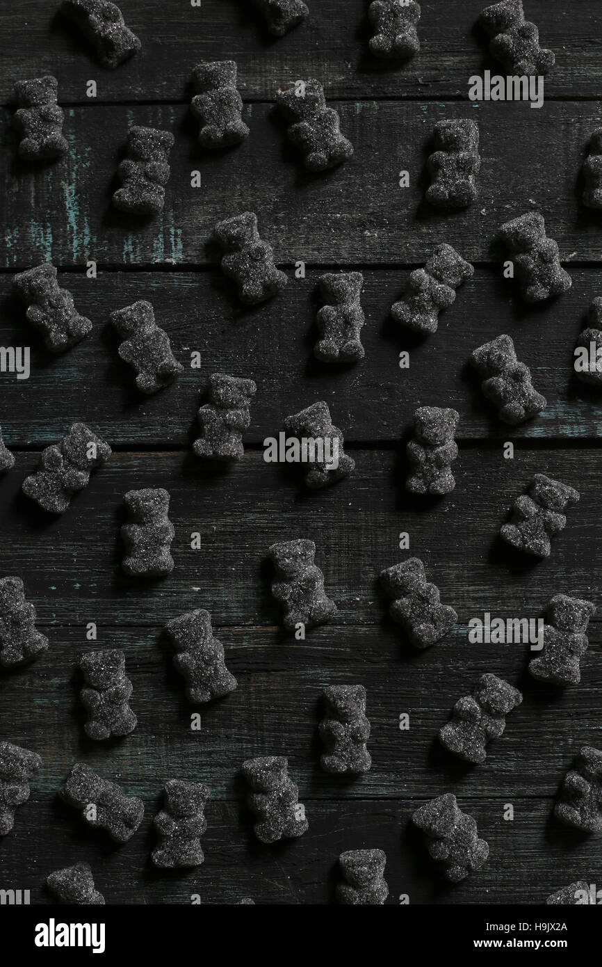 Black gummy bears on wood Stock Photo