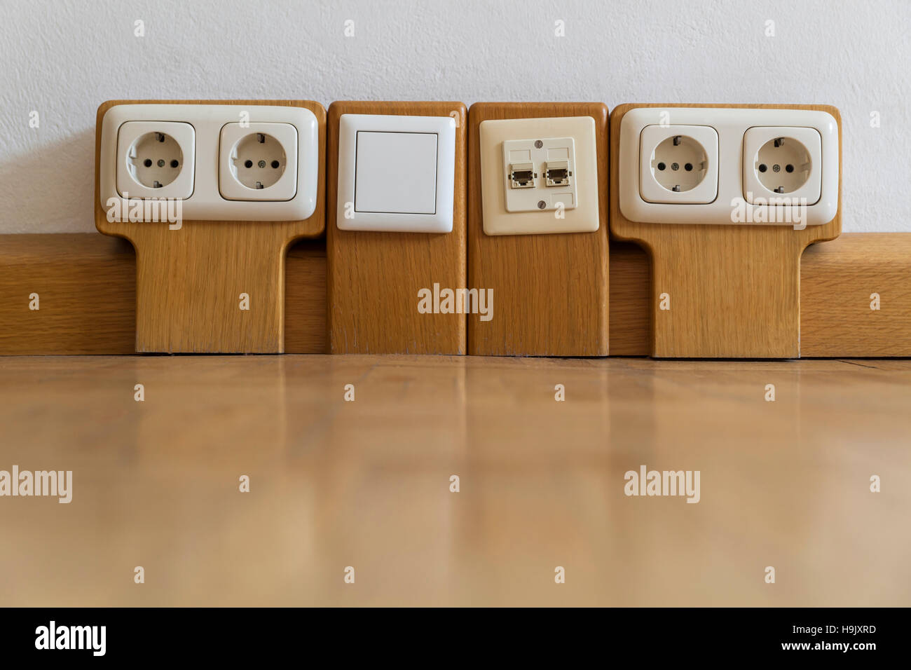 Multiple sockets with wood panelling Stock Photo