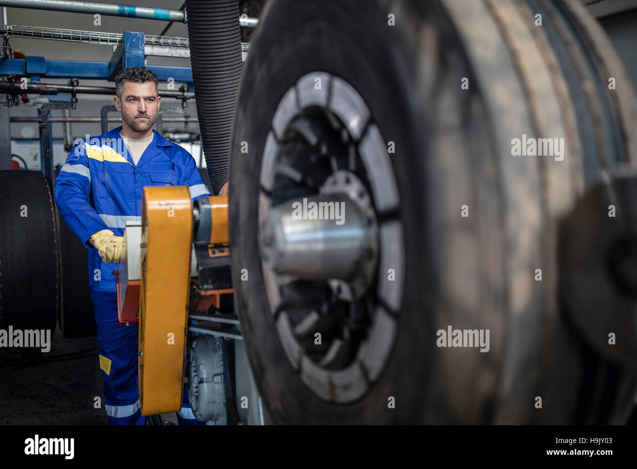 Repairman tuning tire on machine Stock Photo Alamy