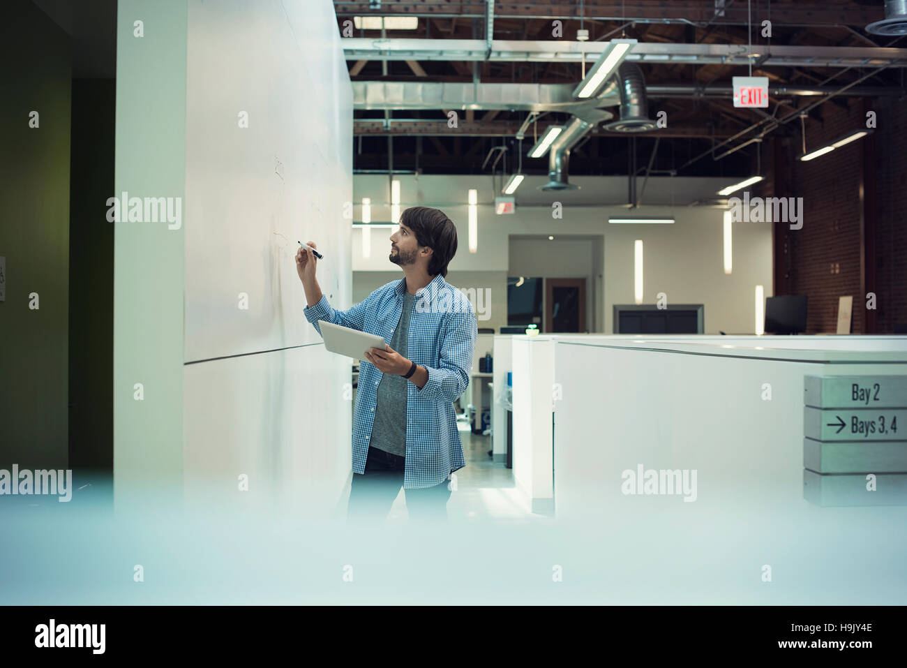 Businessman writing on white board Stock Photo