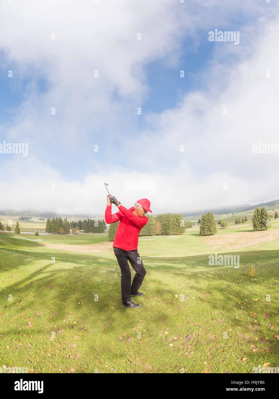 Italy, Veneto, Dolomites, golfer on golf course Stock Photo