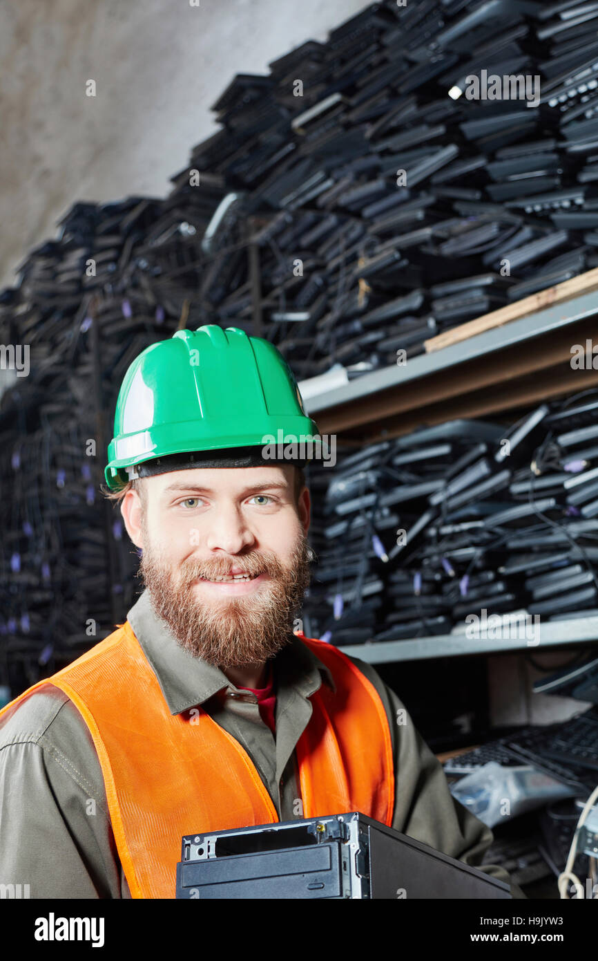 Worker in computer recycling plant holding pc casing Stock Photo Alamy