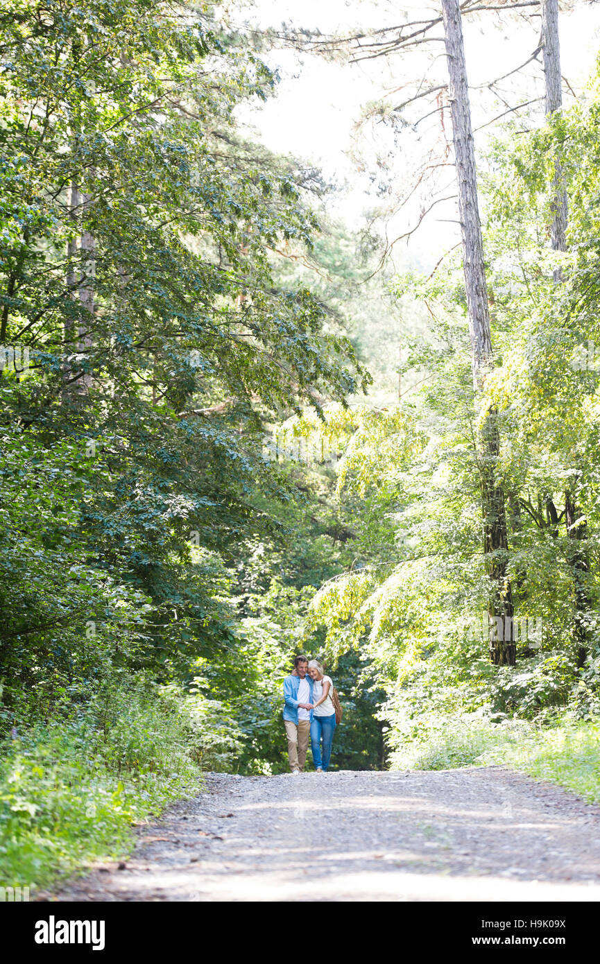 Happy senior couple walking in the woods Stock Photo - Alamy