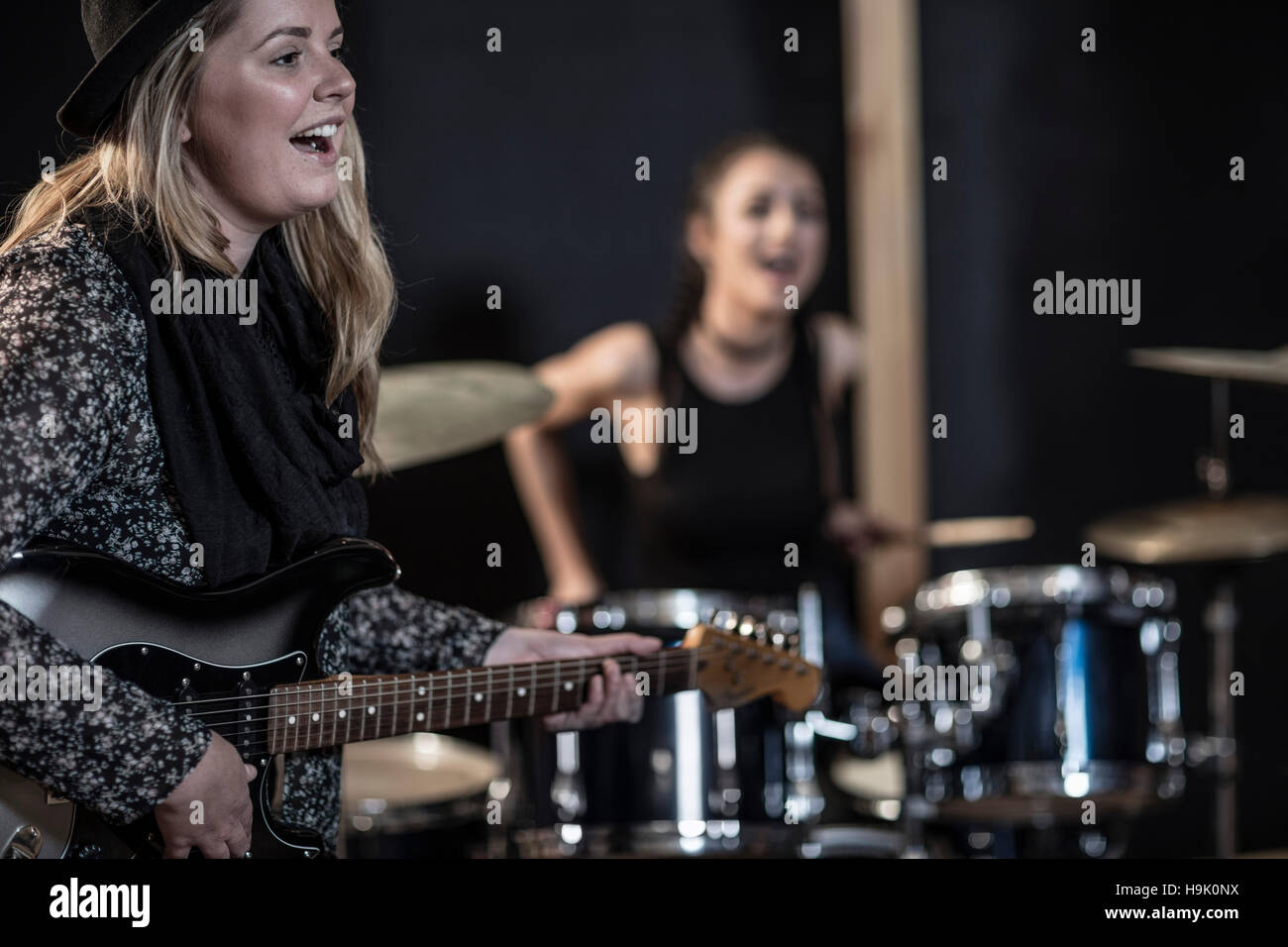 Female rock guitarist and drummer at recording studio Stock Photo - Alamy