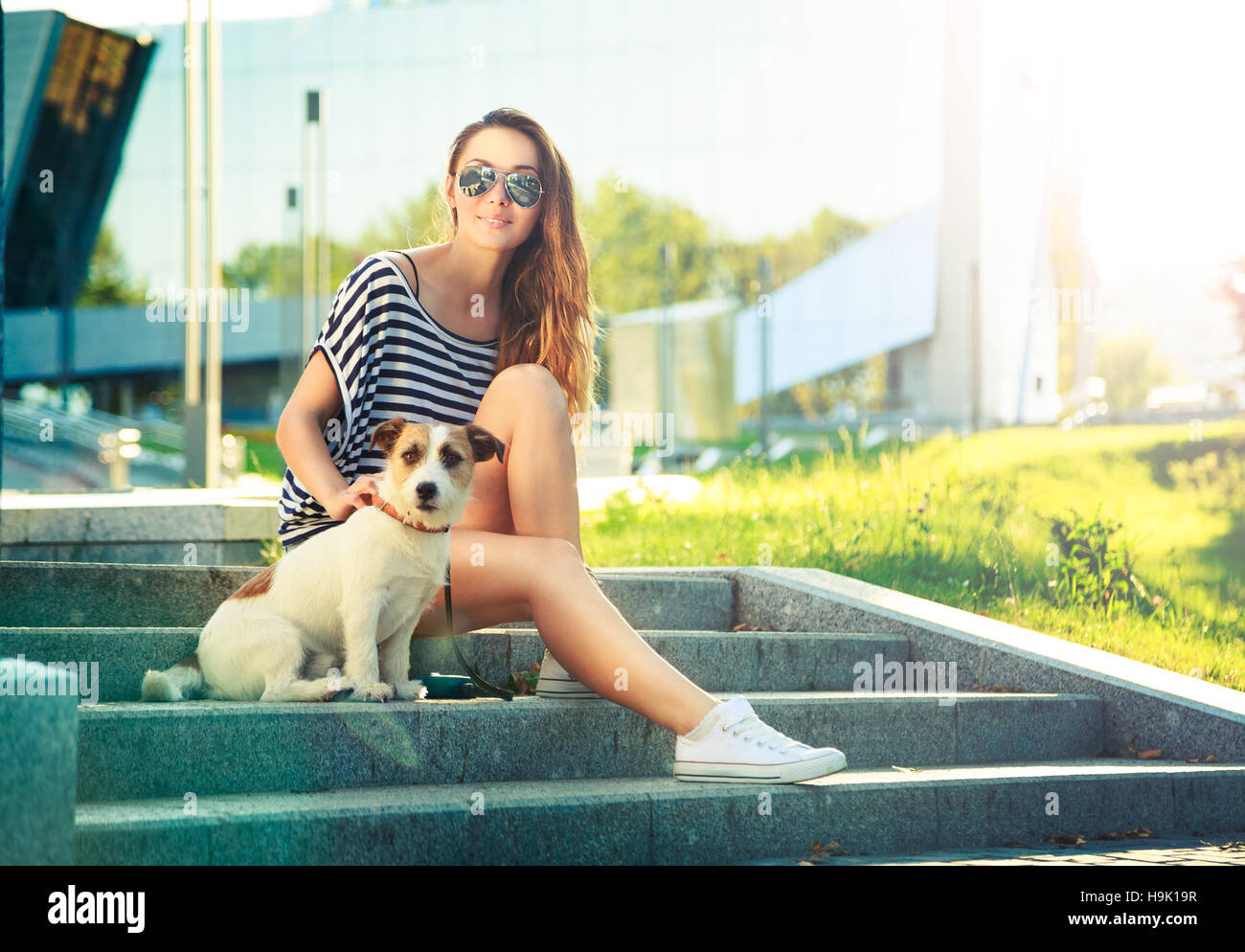 Smiling Trendy Hipster Girl with Dog in the City Stock Photo - Alamy