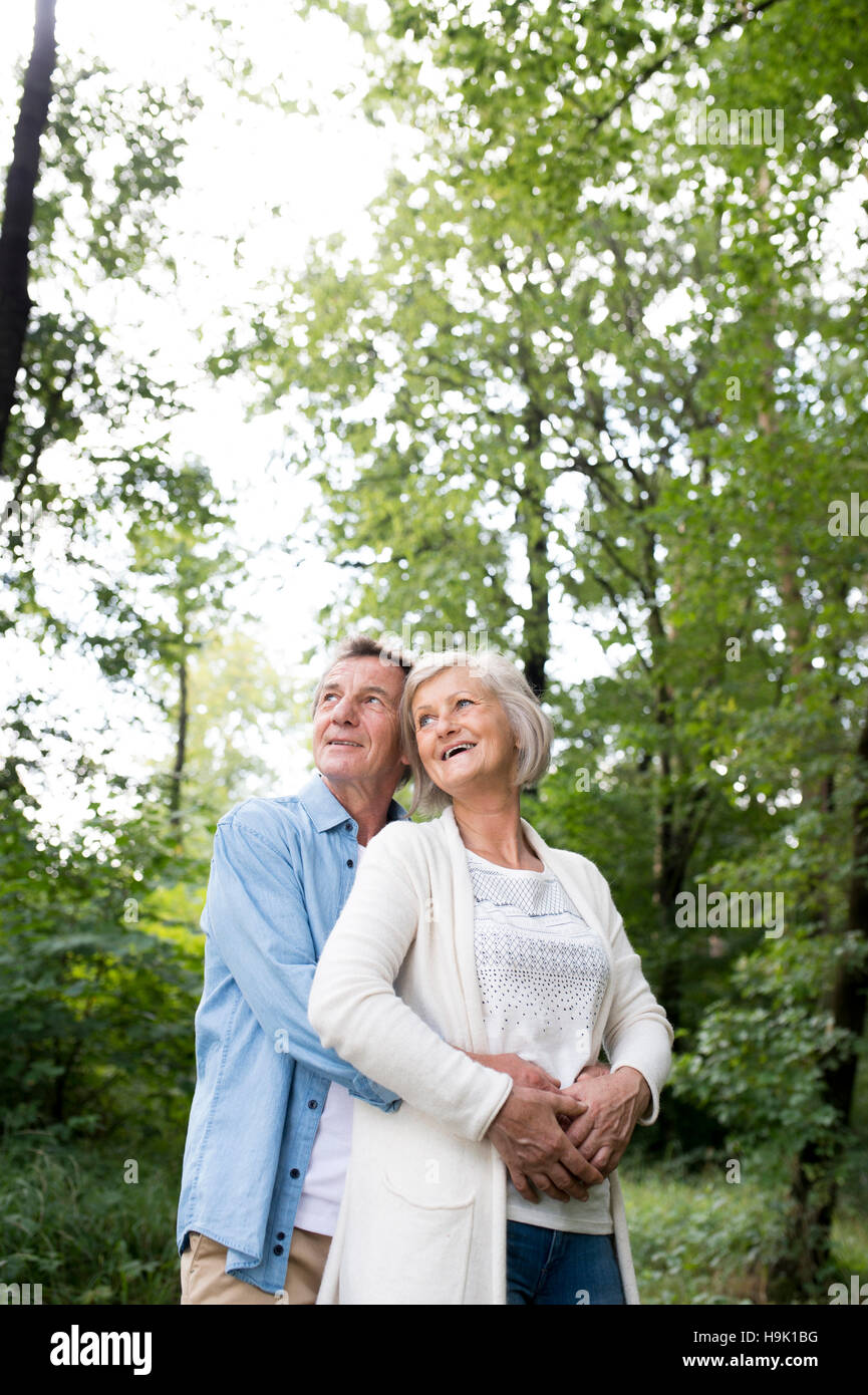 Happy senior couple relaxing together in the woods Stock Photo - Alamy