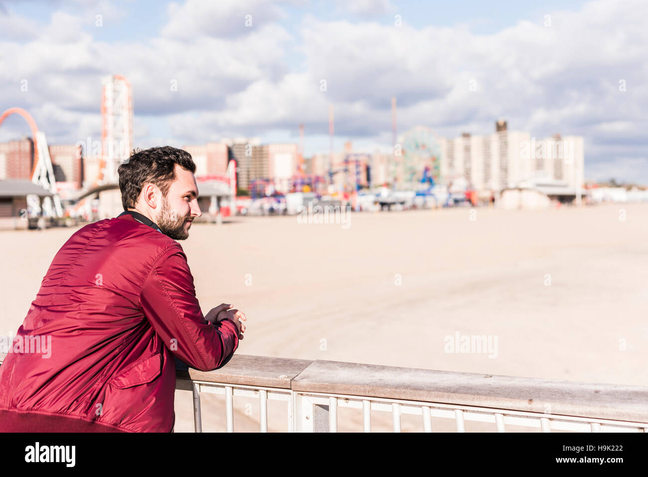 USA, New York City, man standing on bridge on Coney Island Stock Photo