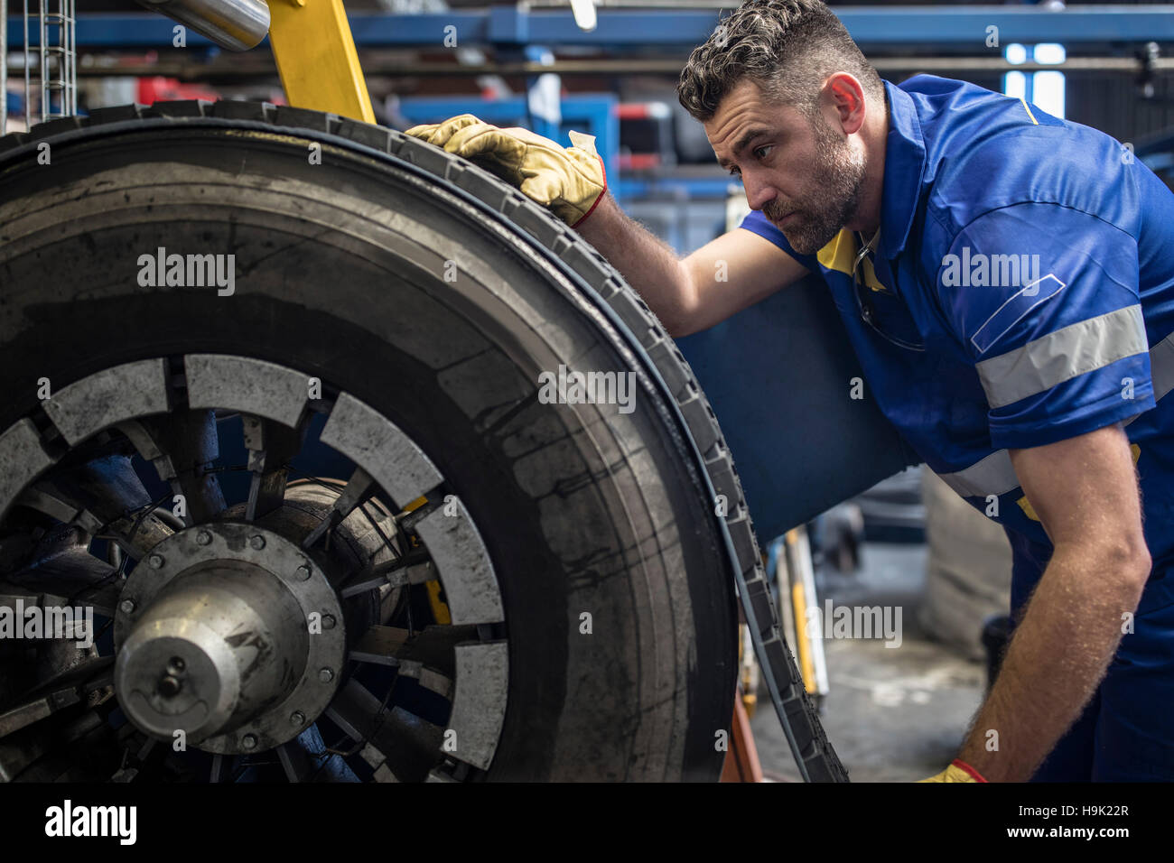 Tire repairer applying tire tread Stock Photo