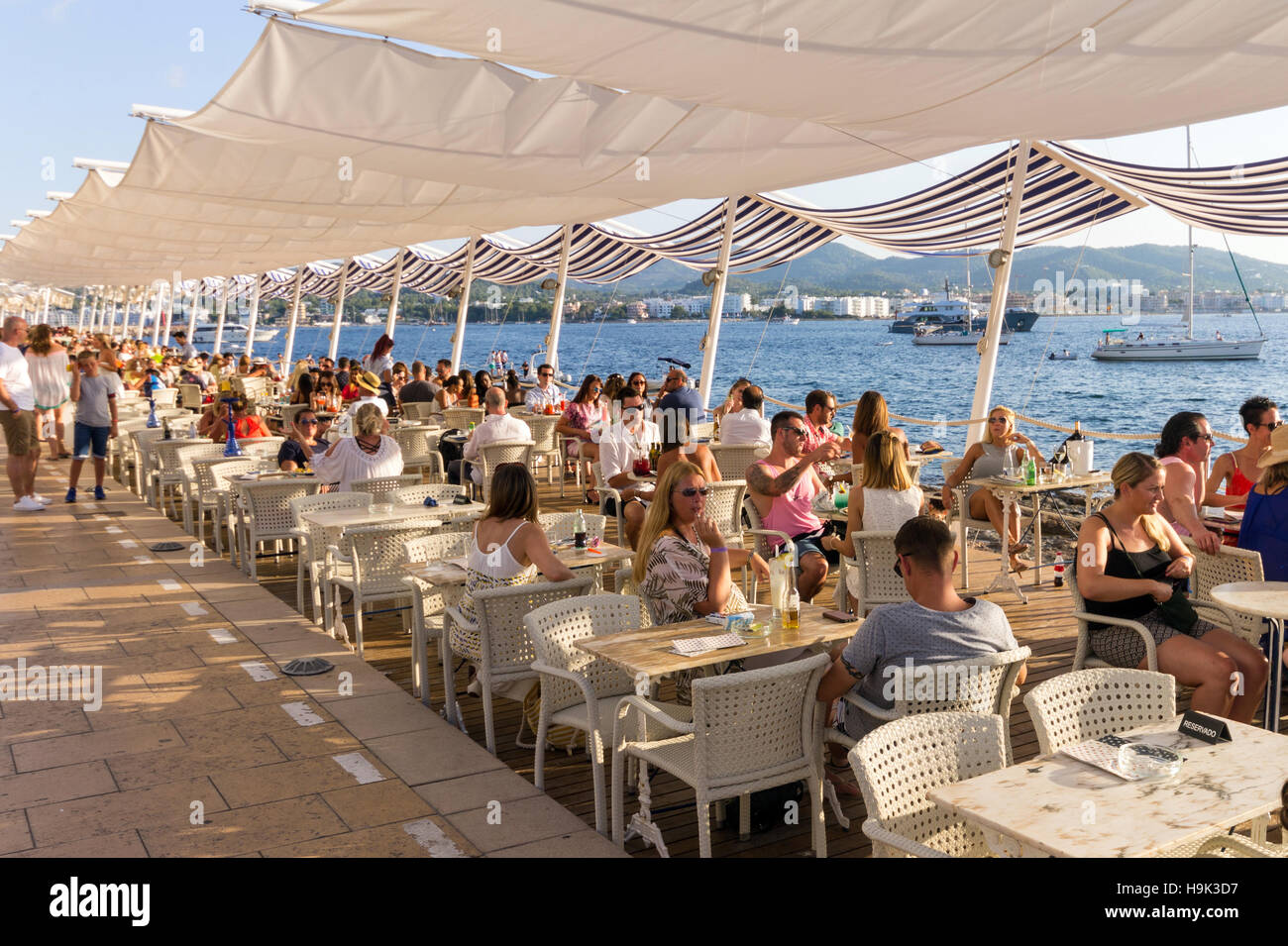 Spain, Balearic Islands, Ibiza, Sant Antoni de Portmany, people at Cafè del Mar Stock Photo