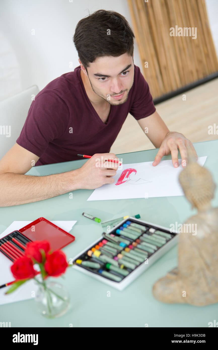 Young male artist doing still life drawing Stock Photo - Alamy