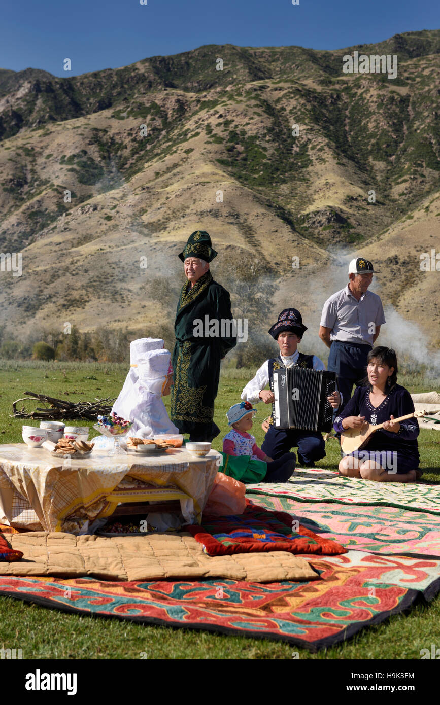 Saty townspeople in traditional garb sing at a picnic in the Chilik river valley Kazakhstan Stock Photo