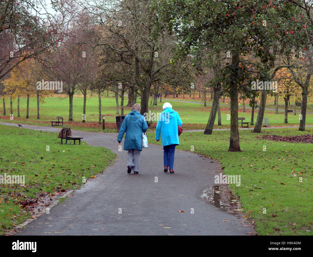 Glasgow park scene two old ladies walking on the path or road Stock Photo
