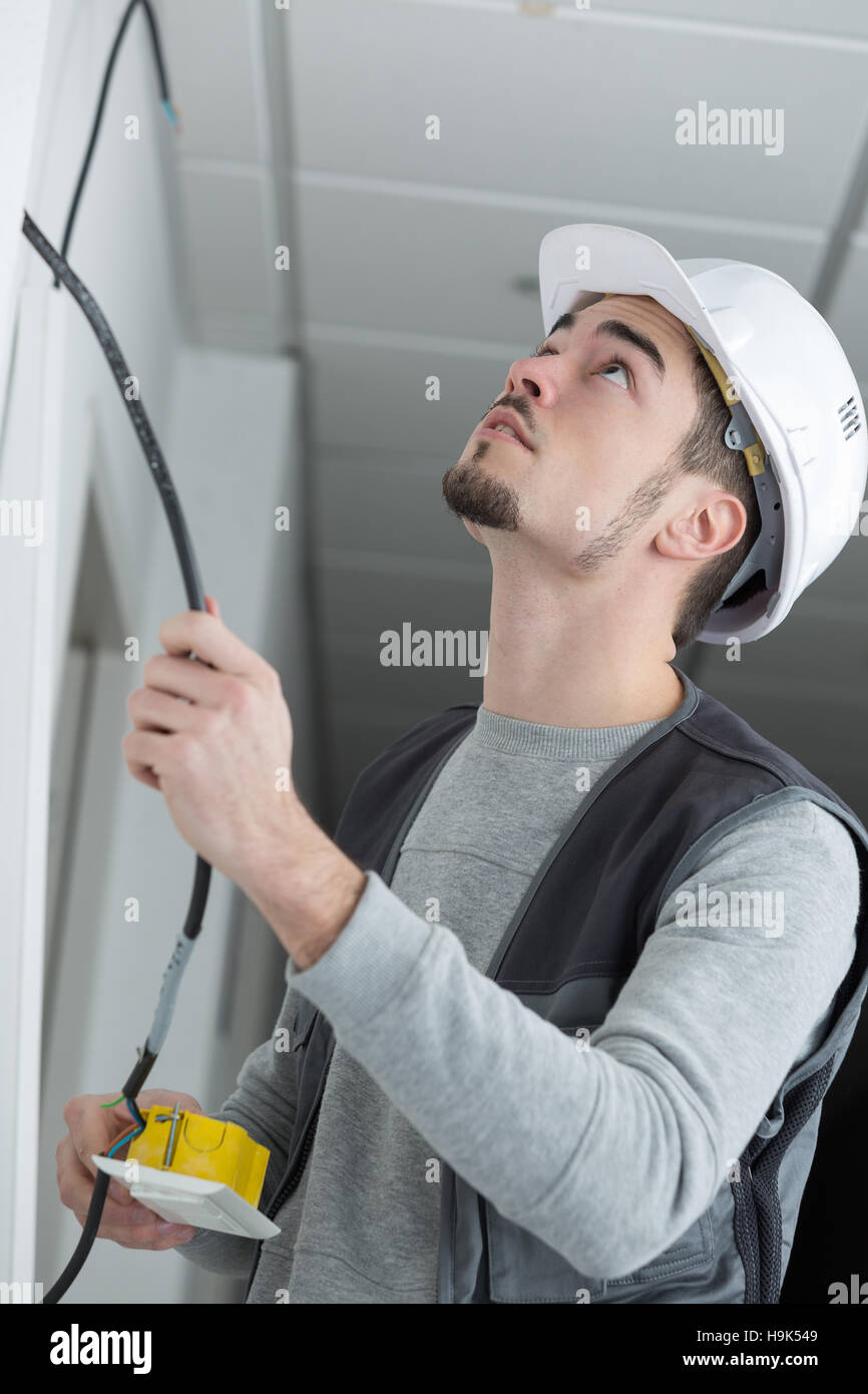 electrician rewiring light switch in office Stock Photo Alamy