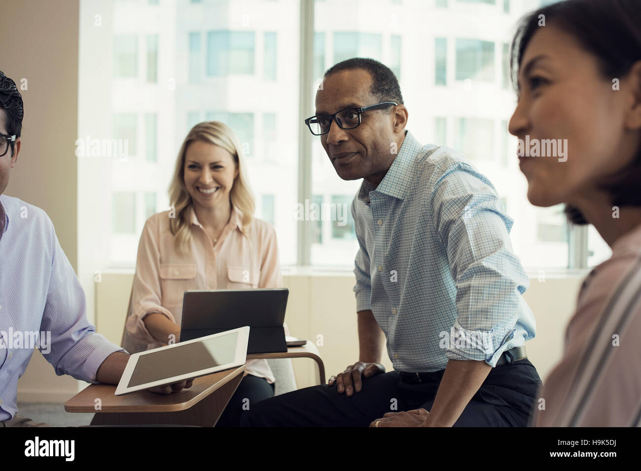 Business people in meeting having interesting discussion Stock Photo