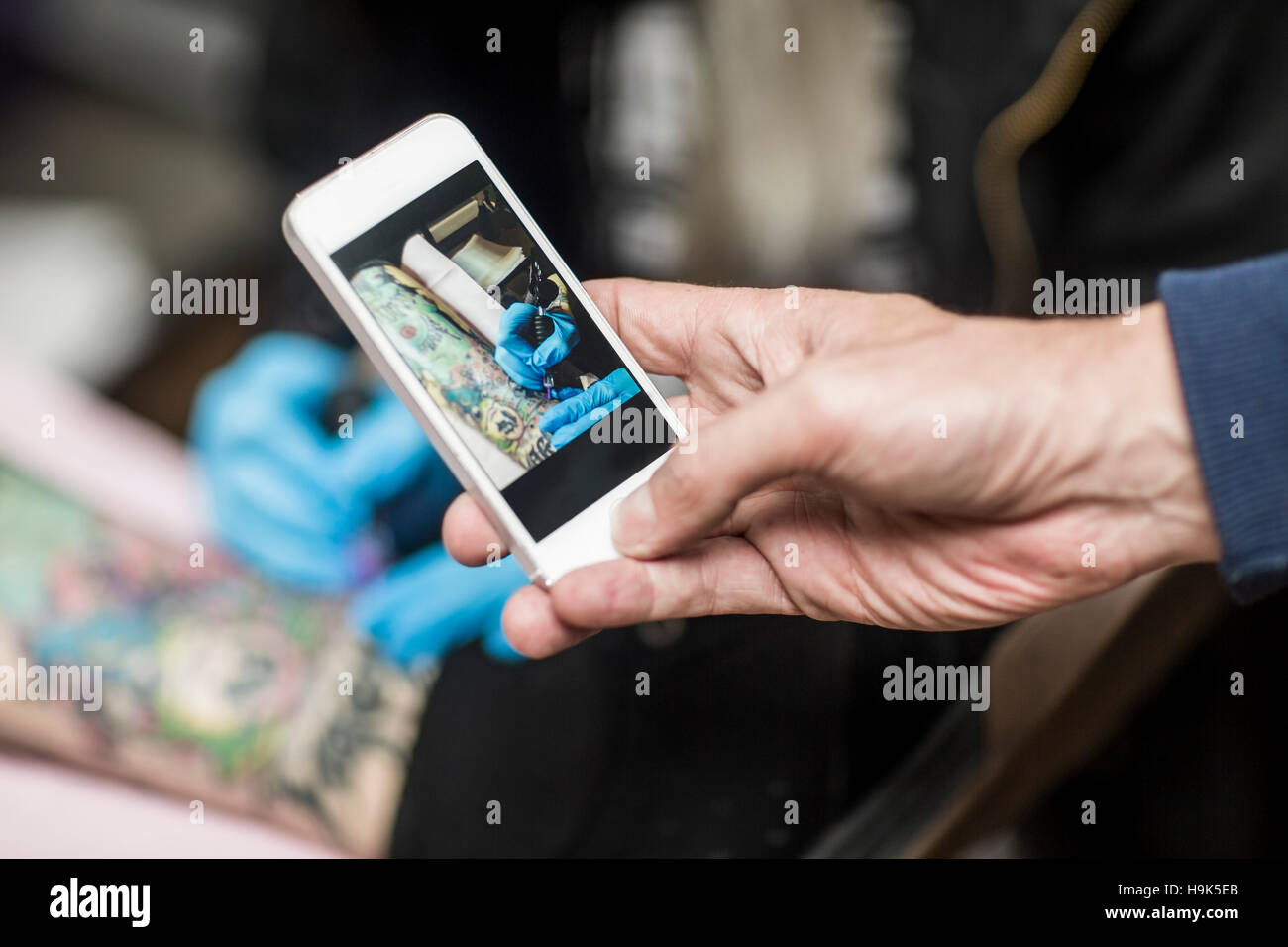 Cell Phone Picture Of Tattoo Artist At Work Stock Photo Alamy