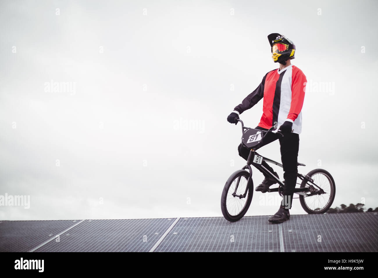 Cyclist standing with BMX bike on starting ramp Stock Photo - Alamy