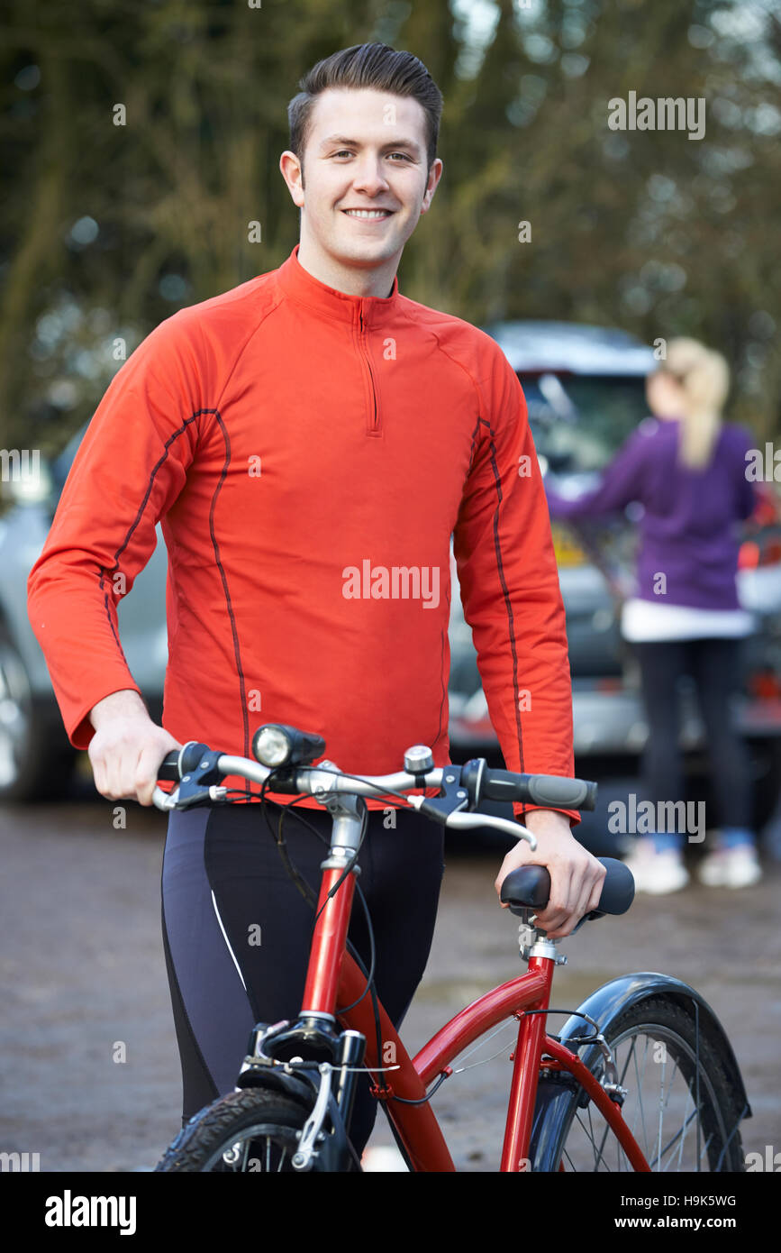 Couple Cycling Taking Mountain Bikes From Rack On Car Stock Photo Alamy