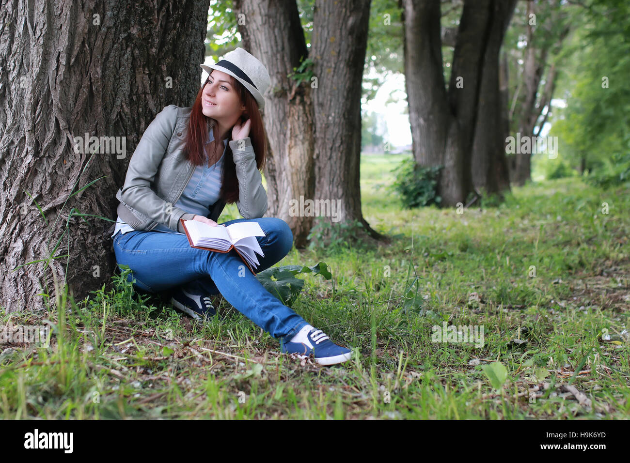 girl with book in park Stock Photo - Alamy