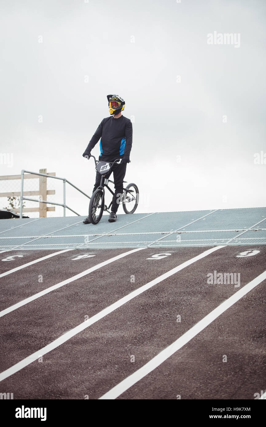Cyclist standing with BMX bike at starting ramp Stock Photo - Alamy
