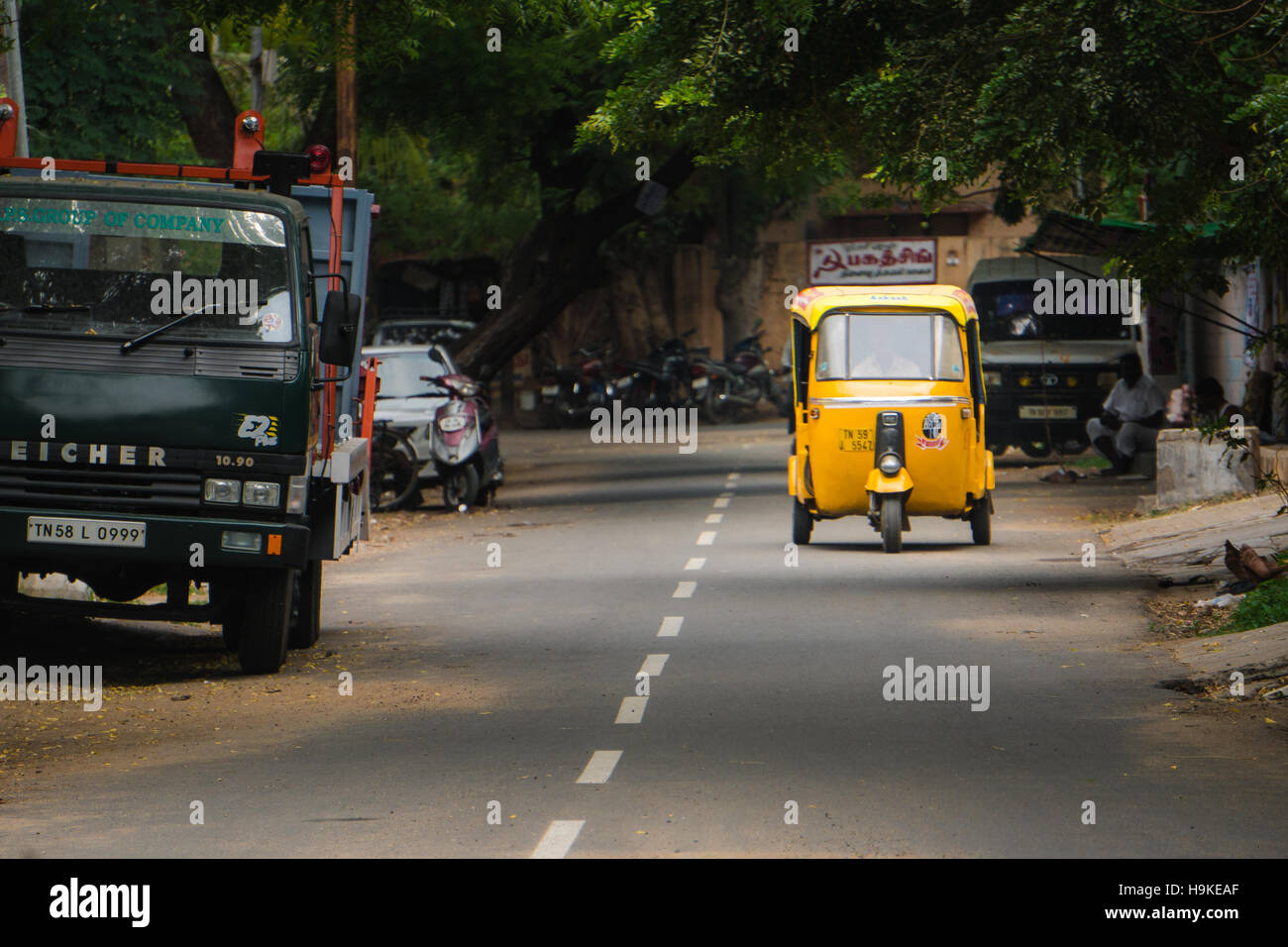 An autorickshaw drives down a back street in Madurai, India. Stock Photo