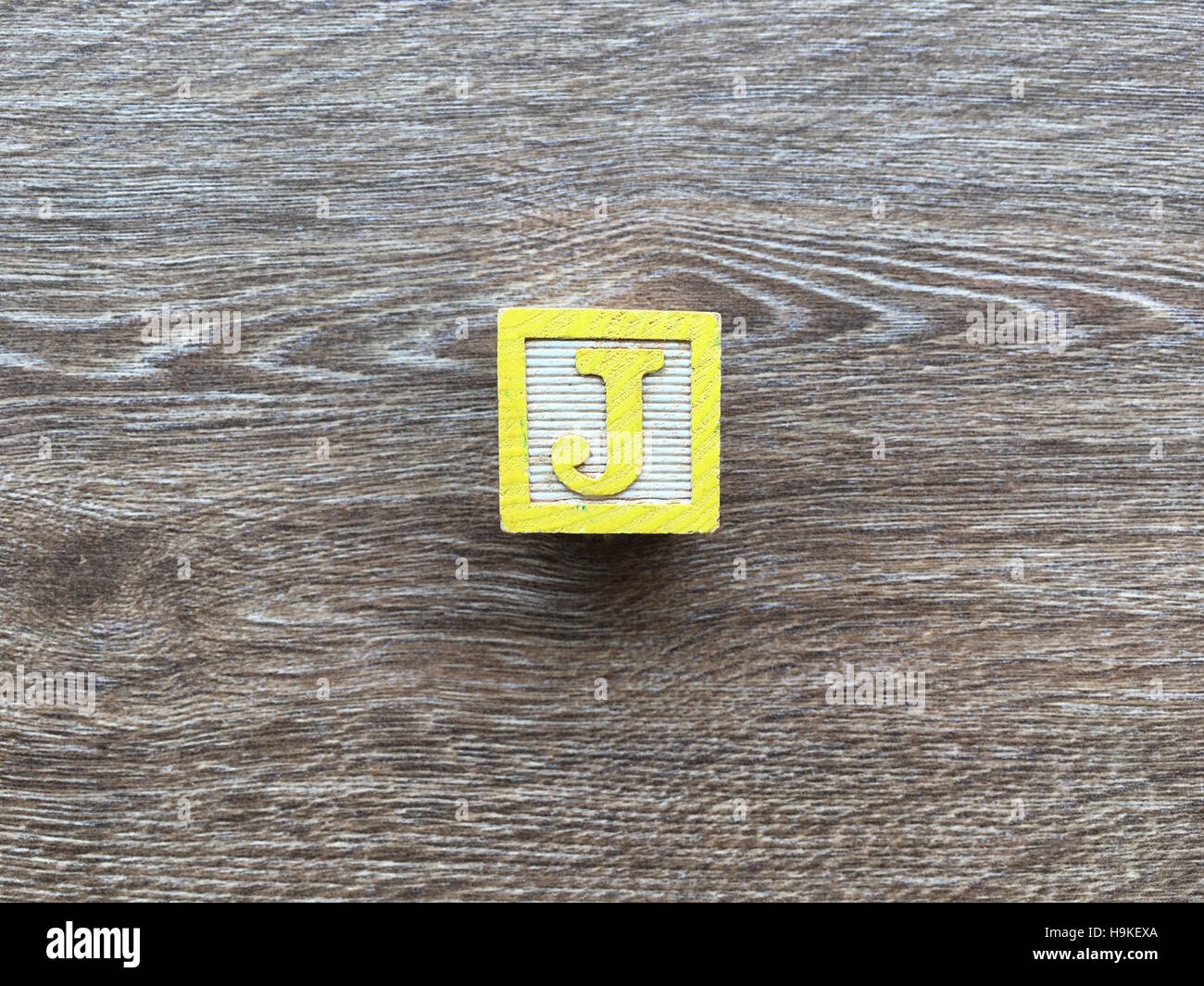 Wood Cube or Block withthe J letter Stock Photo